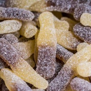 THC infused sour cola bottle gummies dusted in sour sugar